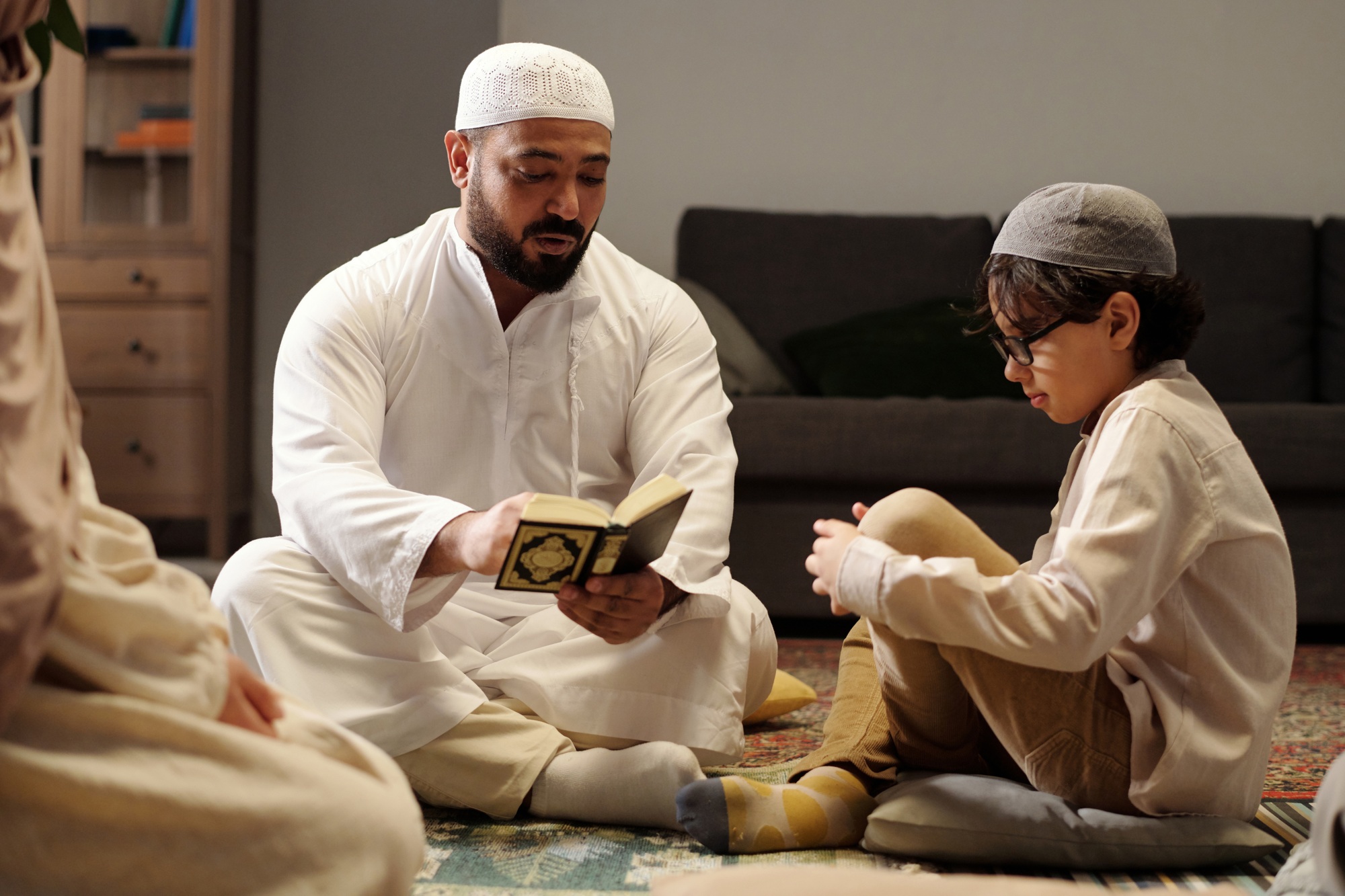 Man Explaining Quran Surah At Family Gathering
