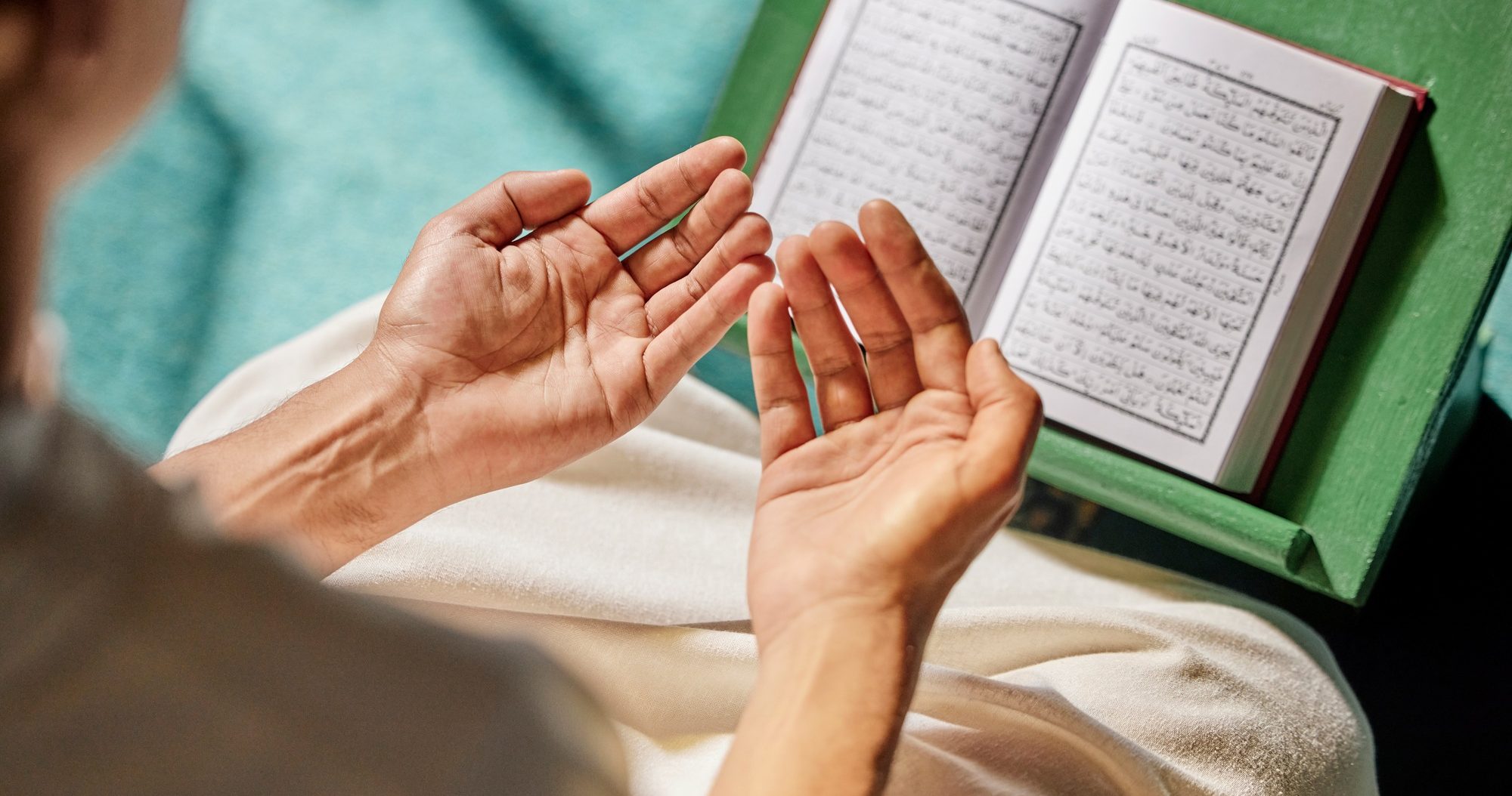 Quran, muslim and man hands praying to allah, god or holy spirit for islamic religion, faith and Sa