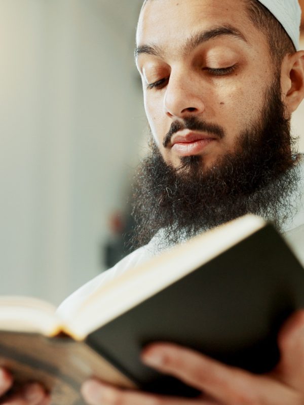Islamic man, reading quran and mosque with faith, reading and mindfulness with worship, search and