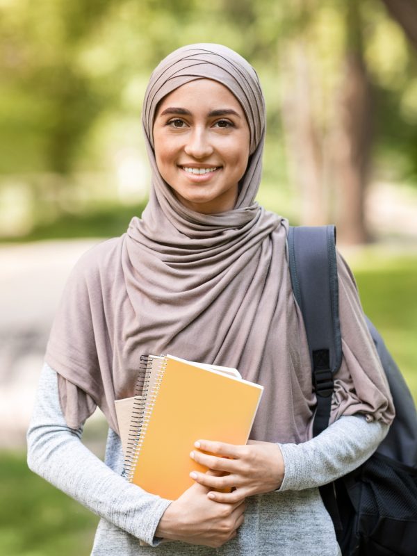 pretty-arab-girl-student-walking-by-park-after-school.jpg