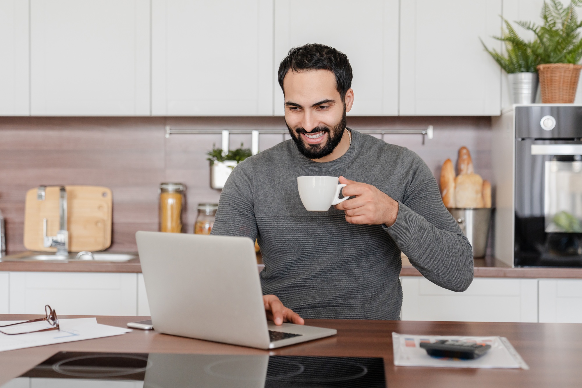 Cheerful Islamic freelancer student businessman e-learning online on laptop