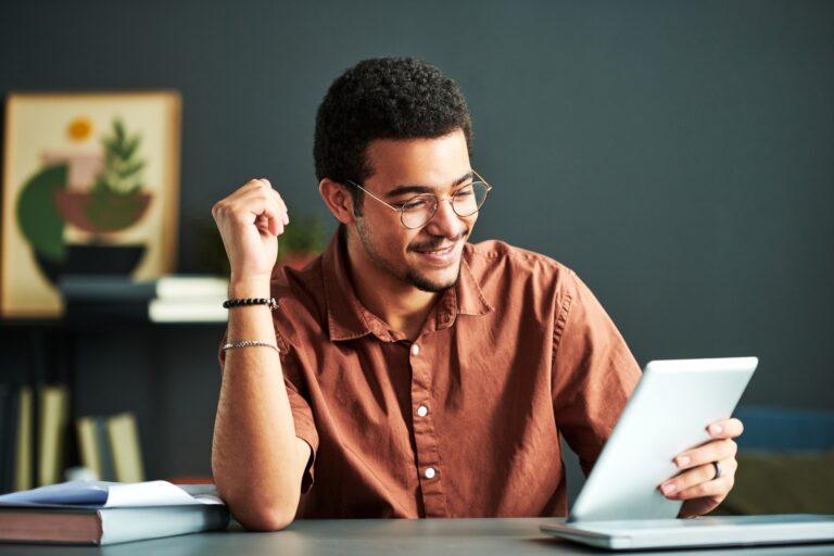 young-smiling-student-of-online-course-of-study-looking-at-tablet-screen