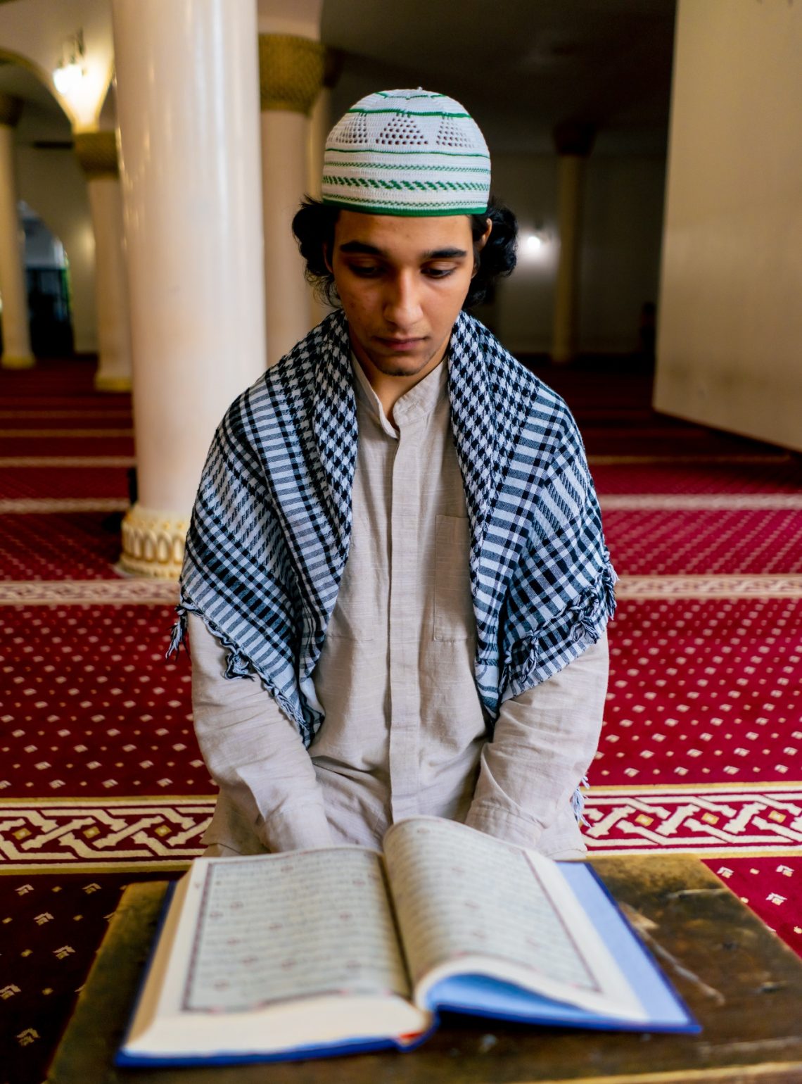 a-muslim-man-sits-in-silence-on-the-carpet-in-holy-mosque-prays-reads-the-koran-and-turns-to-allah
