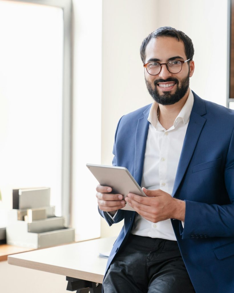 smiling-trustful-islamic-businessman-tutor-teacher-using-digital-tablet-for-remote-work