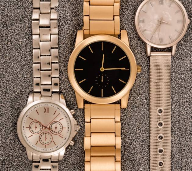 top-view-of-luxury-wristwatches-lying-on-golden-sa-2024-11-16-00-14-38-utc