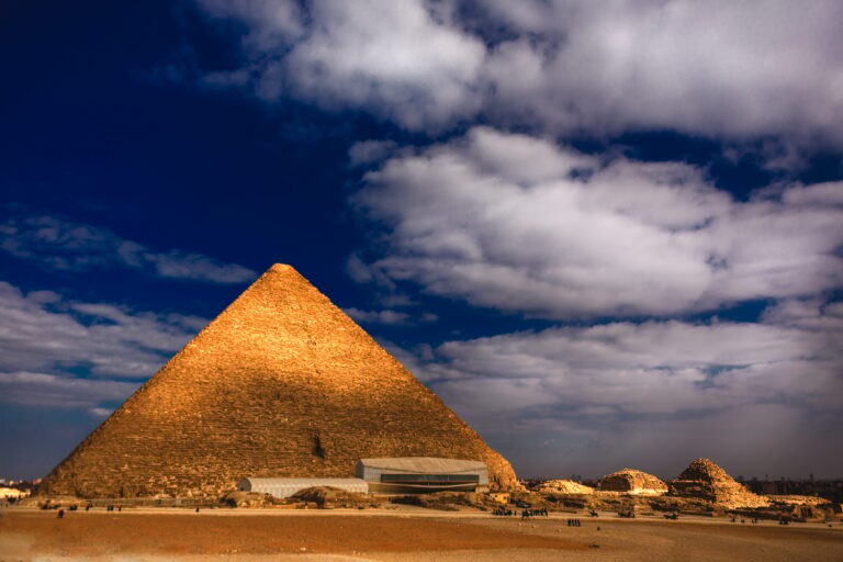 Pyramid of Giza in Egypt against a cloudy blue sky