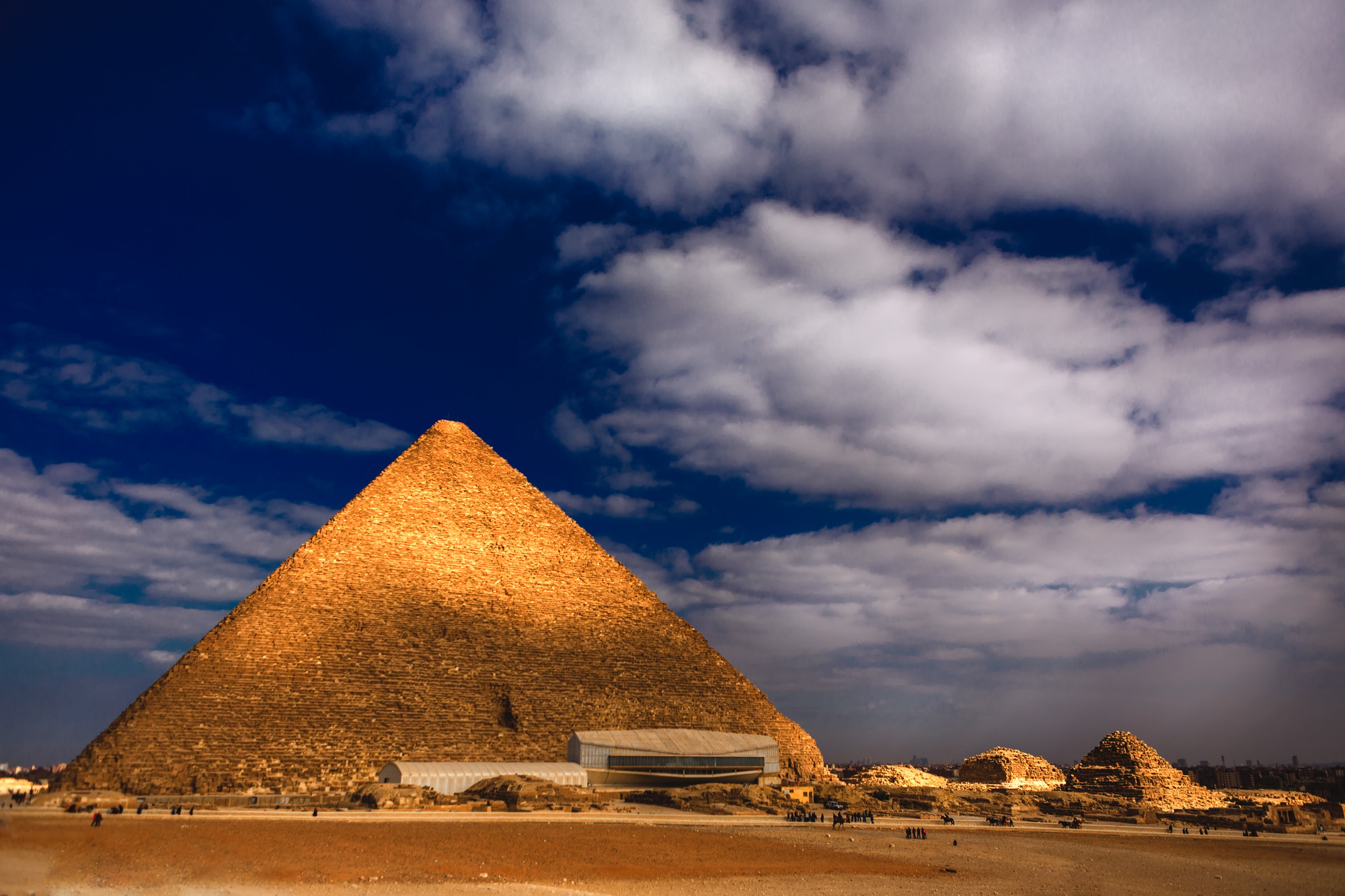 Pyramid of Giza in Egypt against a cloudy blue sky
