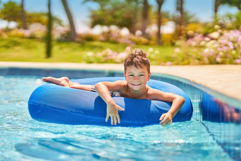 Picture of a small boy having fun in aquapark outdoor on tube